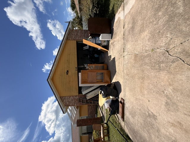 Furniture and household items staged outside a home during a full home cleanout.